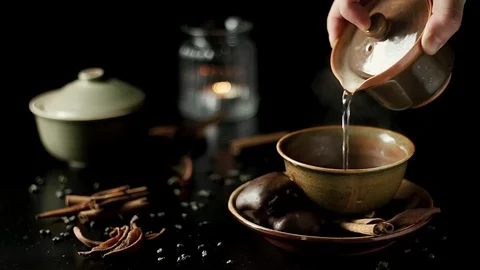Beautiful still life footage of a hand pouring tea into a japanese tea cup. Stock Footage