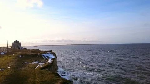 Beautiful stone cliffs, oceanwaves and oceanscape aerial reveal shot at sunset. Video stock 101077440