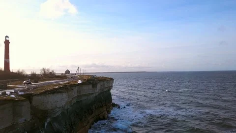 Beautiful stone cliffs, oceanwaves and oceanscape aerial reveal shot at sunset. Stock Footage 101077471