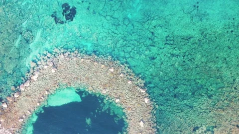 A beautiful stone path is visible through the turquoise clear sea water. Video stock 155091608