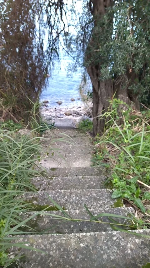 A beautiful stone staircase leads down to the sea Video stock 303754469