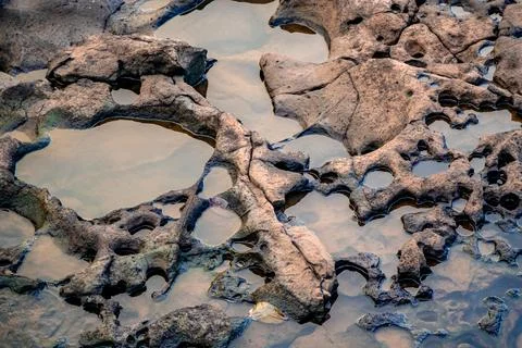 A beautiful stone structure with gaps filled with water. wallpaper background Fotos de archivo