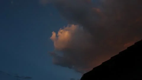 Beautiful Storm Clouds Building over Dark Roof Line Stock Footage 10573514
