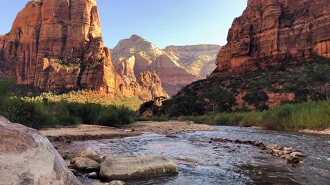 Beautiful stream flowing through the base of a spectacular canyon Stock Footage 113945038