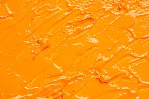 Beautiful strokes of orange oil paint as background, closeup Stock Photos