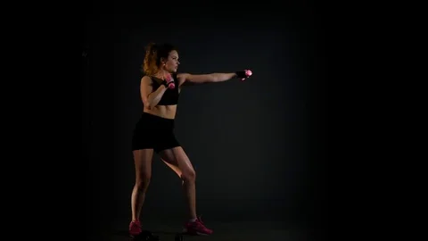 Beautiful strong woman exercises with dumbbells Stock Footage