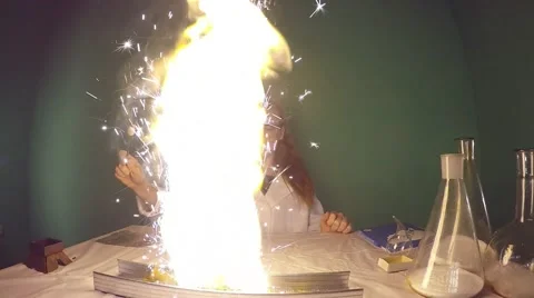 Beautiful student doing chemistry experiment, followed by a flash of fire. Video stock 59952897