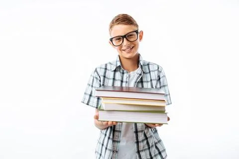 Beautiful student holding a stack of books, a botanist goes with books to stu Stock Photos
