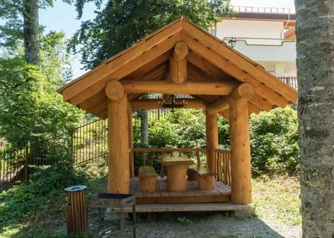Beautiful summer house from a log of a large tree with barbecue for barbecue 스톡 사진