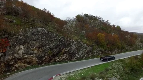 Beautiful Summer Mountain Road. Footage. A car travels along on a twisty Stock Footage