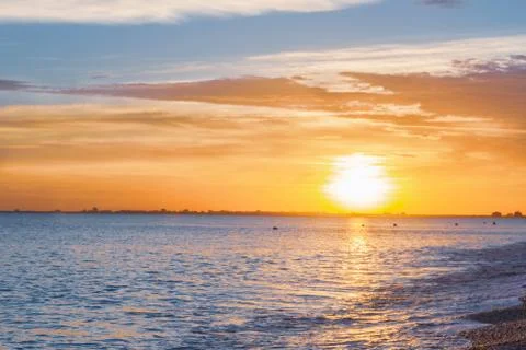 Beautiful summer sunset with clouds over the sea Stock Photos