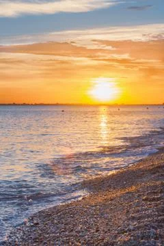 Beautiful summer sunset with clouds over the sea Stock Photos