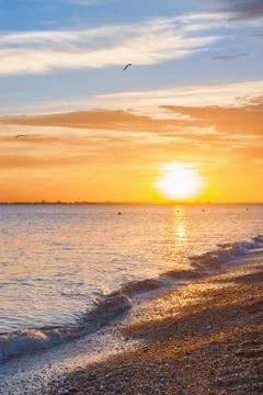 Beautiful summer sunset with clouds over the sea Stock Photos