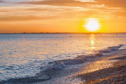 Beautiful summer sunset with clouds over the sea Stock Photos
