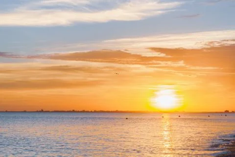Beautiful summer sunset with clouds over the sea Stock Photos