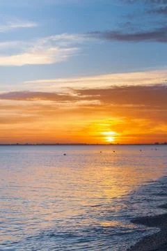 Beautiful summer sunset with clouds over the sea Stock Photos