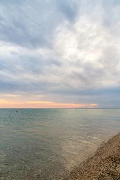 Beautiful summer sunset with clouds over the sea Stock Photos