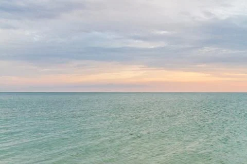 Beautiful summer sunset with clouds over the sea Stock Photos