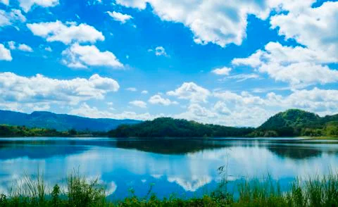 Beautiful summer sunset in the lake with blue sky Stock Photos