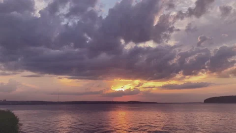 Beautiful summer sunset. Movement of clouds in the evening sky View from the Stock Footage 232296143
