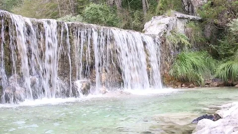 Beautiful summer waterfall with blue water in the Alps, near Lake Garda, Italy Stock Footage