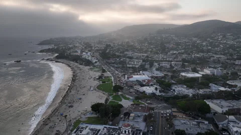 Beautiful sun beam through clouds on Laguna beach aerial Stock Footage 283519756