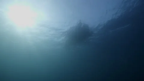 Beautiful sun light rays shining through ocean surface. Lonely diver boat Stock Footage 289329038