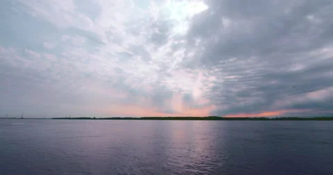 Beautiful sun rays in a colorful cloudy sky at the lake Stock Footage 130988034