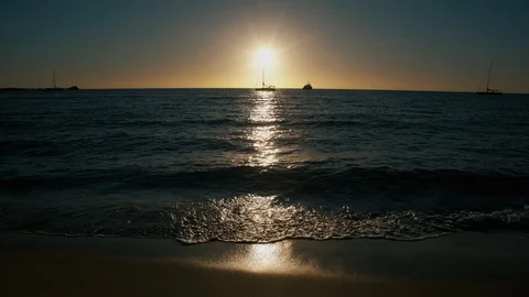 Beautiful Sun rays dancing on waves and sand  Stock Footage 122865999