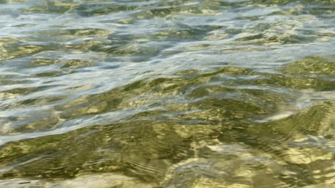 Beautiful sun reflection and light caustics on a sandy bottom through cryst.. Stock Footage 336976489