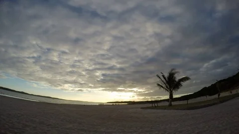 A beautiful sun sets behind a hill reflecting in the bay. Africa.Time laps. Stock Footage 71405010