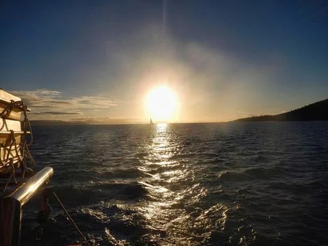 The beautiful sun is setting gracefully over a tranquil body of water Whitsunday Stock Photos