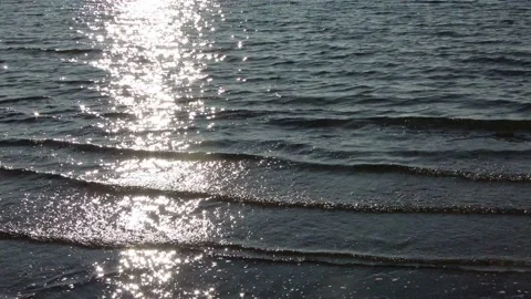 Beautiful sunlight reflections at the water surface at a baltic sea beach Stock Footage 142769288
