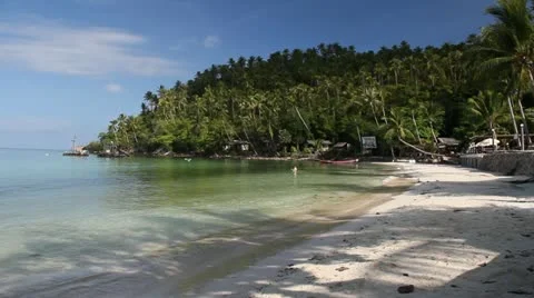 Beautiful sunny beach calm shallow water resorts and restaurants. Stock Footage