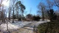 Beautiful sunny winter day with snow in city park woman hiking baby carriage 4k or 4k+ Resolution
