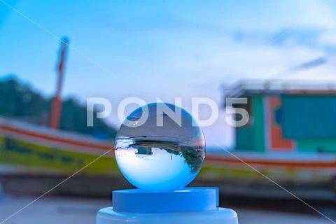Beautiful sunrise in clear quartz crystal ball Stock Photos