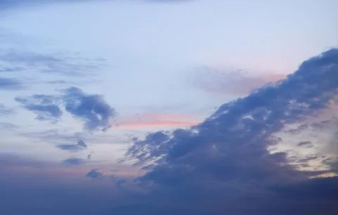 A beautiful sunrise sky with a gradient from deep blue to soft pink and gold Stock Photos