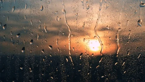Beautiful sunrise while raining. Watching the sunrise behind the window. 4K Stock Footage 83503437