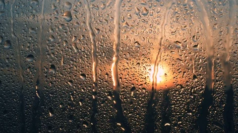 Beautiful sunrise while raining. Watching the sunrise behind the window. 4K Stock Footage 83503825
