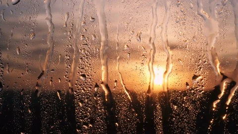 Beautiful sunrise while raining. Watching the sunrise behind the window. 4K Stock Footage 83504202