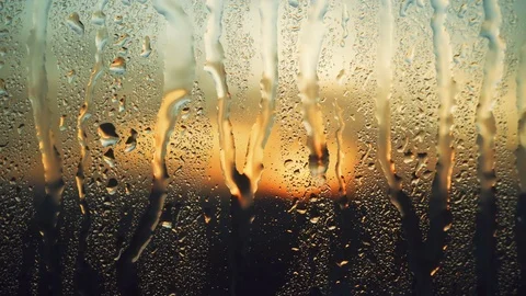 Beautiful sunrise while raining. Watching the sunrise behind the window. 4K Stock Footage 83504587