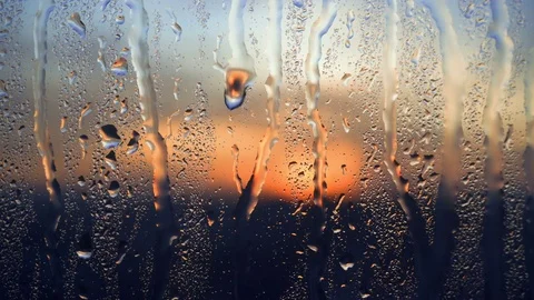 Beautiful sunrise while raining. Watching the sunrise behind the window. 4K Stock Footage 83504820