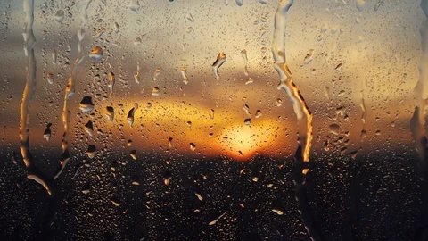 Beautiful sunrise while raining. Watching the sunrise behind the window. 4K Stock Footage 83505156