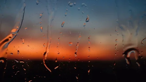 Beautiful sunrise while raining. Watching the sunrise behind the window. 4K Stock Footage 83505373