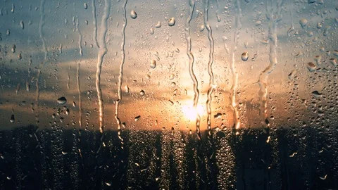 Beautiful sunrise while raining. Watching the sunrise behind the window. 4K Video stock 83534593