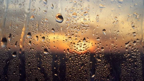 Beautiful sunrise while raining. Watching the sunrise behind the window. 4K Video stock 83537016