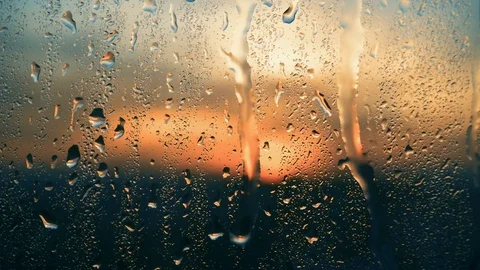 Beautiful sunrise while raining. Watching the sunrise behind the window. 4K Stock Footage 83581570