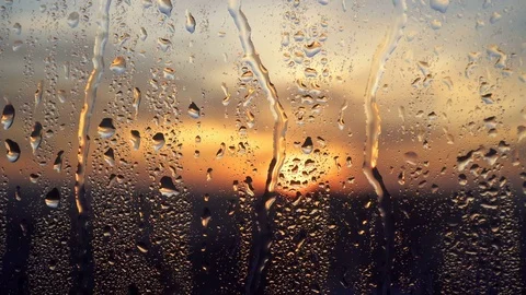 Beautiful sunrise while raining. Watching the sunrise behind the window. 4K Stock Footage 83582441