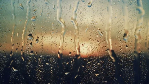 Beautiful sunrise while raining. Watching the sunrise behind the window. 4K Stock Footage 83821610