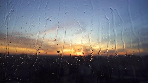 Beautiful sunrise while raining. Watching the sunrise behind the window. 4K Stock Footage 83821940